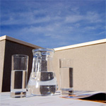 Water jug and glasses on table in the sun